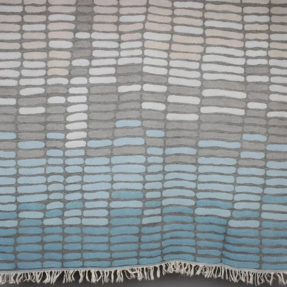 Cotton towel with gauze texture with a geometric woven design and eyelash fringe.