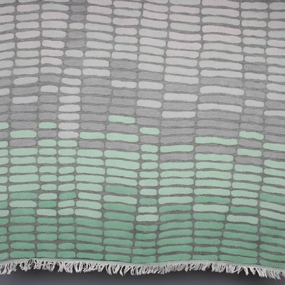 Cotton towel with gauze texture with a geometric woven design and eyelash fringe.