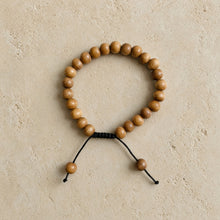 Natural wood sandalwood mala bracelet with round sandalwood beads and simple black cord closure for spiritual practice