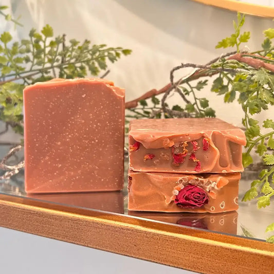 Sandalwood Rose Soap Bar is made with raw shea butter, organic olive oil, organic coconut oil, organic castor oil, sandalwood powder, kaolin clay, French pink clay, and a blend of sandalwood; rose essential oils, topped with homegrown rose buds and/or rose petals.