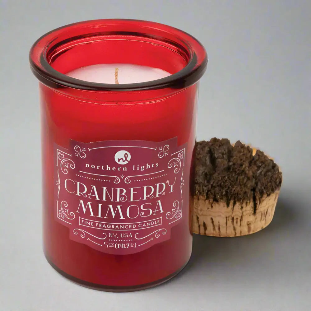 Red glass jar candle with a wick from Seasonal Spirit Candles inspired by favorite holiday cocktails for a festive mood