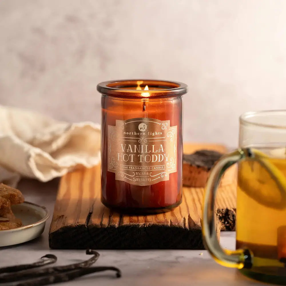 Lit amber Vanilla Hot Toddy candle from Seasonal Spirit Candles for a festive mood