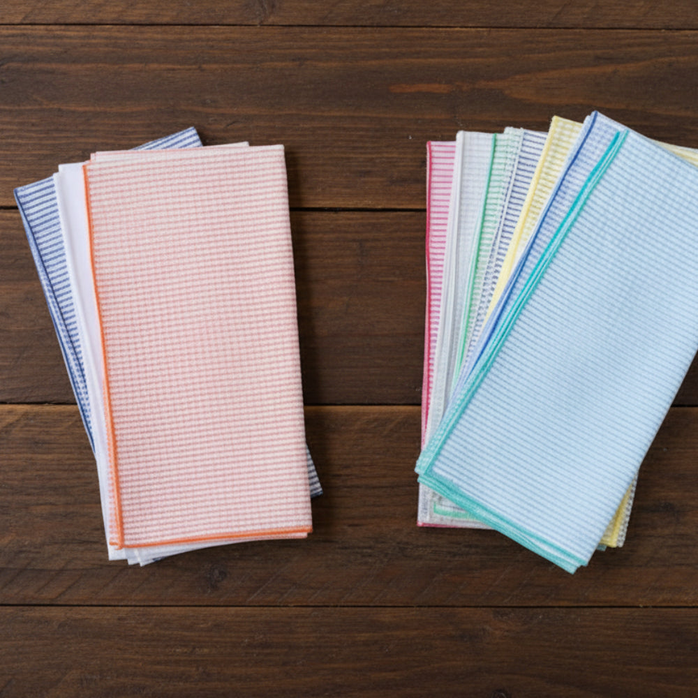 Stack of 8 handcrafted seersucker cloth napkins in pastel stripes