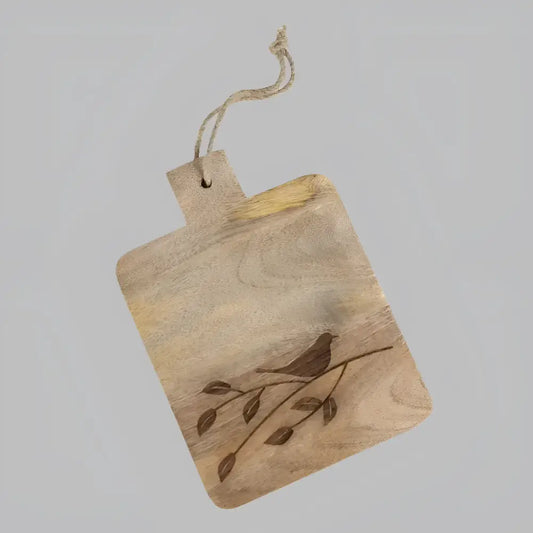 wooden serving board with etched bird on branch.