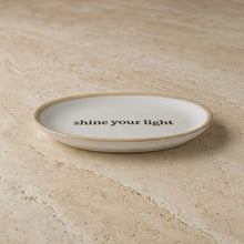 White ceramic catch-all dish with beige rim and shine your light phrase perfect for petite oval lip balm or trinkets
