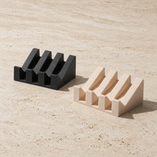 Black and beige silicone soap dish with integrated self-drainage and slanted slot design for bar soap storage