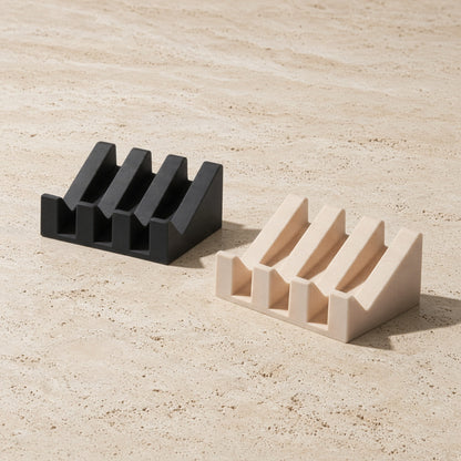 Black and beige silicone soap dish with integrated self-drainage and slanted slot design for bar soap storage