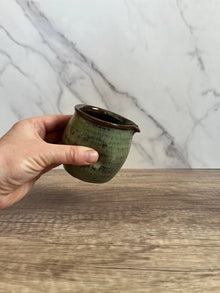 Handcrafted Thumb Divot 8 oz ceramic pitcher with mottled green glaze