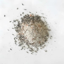 A pile of pink himalayan soaking salts mixed with dried lavender buds for rejuvenate with lavender and herb