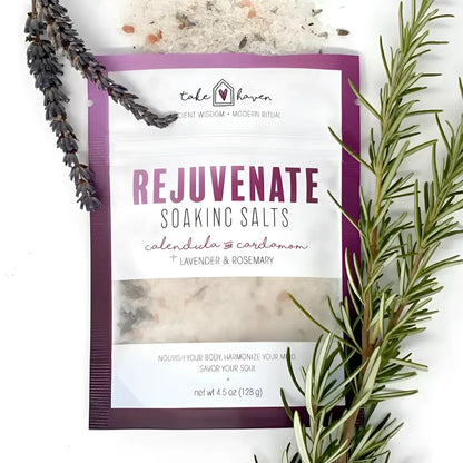 Purple and white pouch of take haven soaking salts to rejuvenate with lavender rosemary calendula and cardamom using essential oils