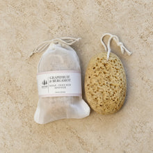 Natural beige infused natural sponge with shea butter soap and essential oils featuring a porous surface and hanging loop