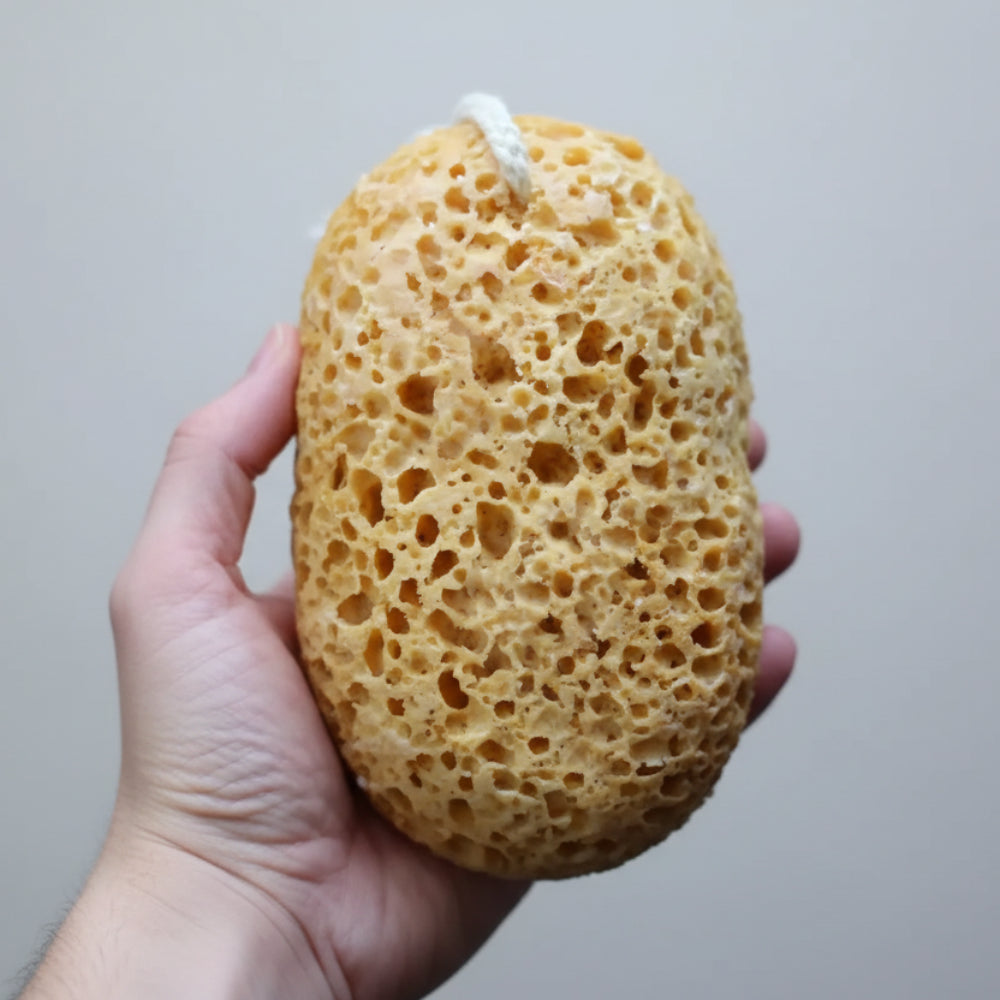 Handmade eco-friendly soap infused beige loofah sponge with textured surface