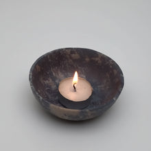 Lit handmade soapstone bowl with tea light candle