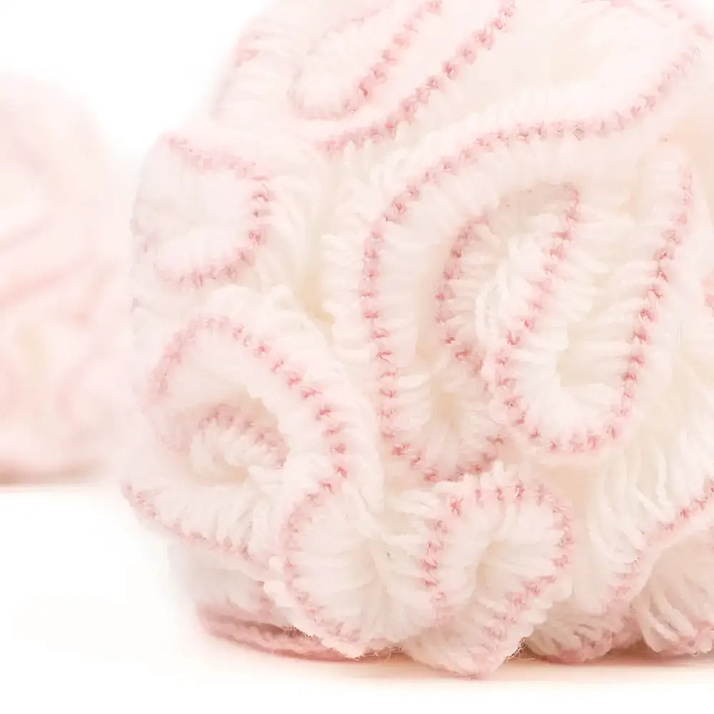 White lace baby bonnet with pink trim and floral cotton pattern