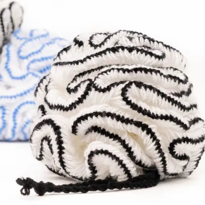 White and black bathing pouf in soft organic cotton bath pouf