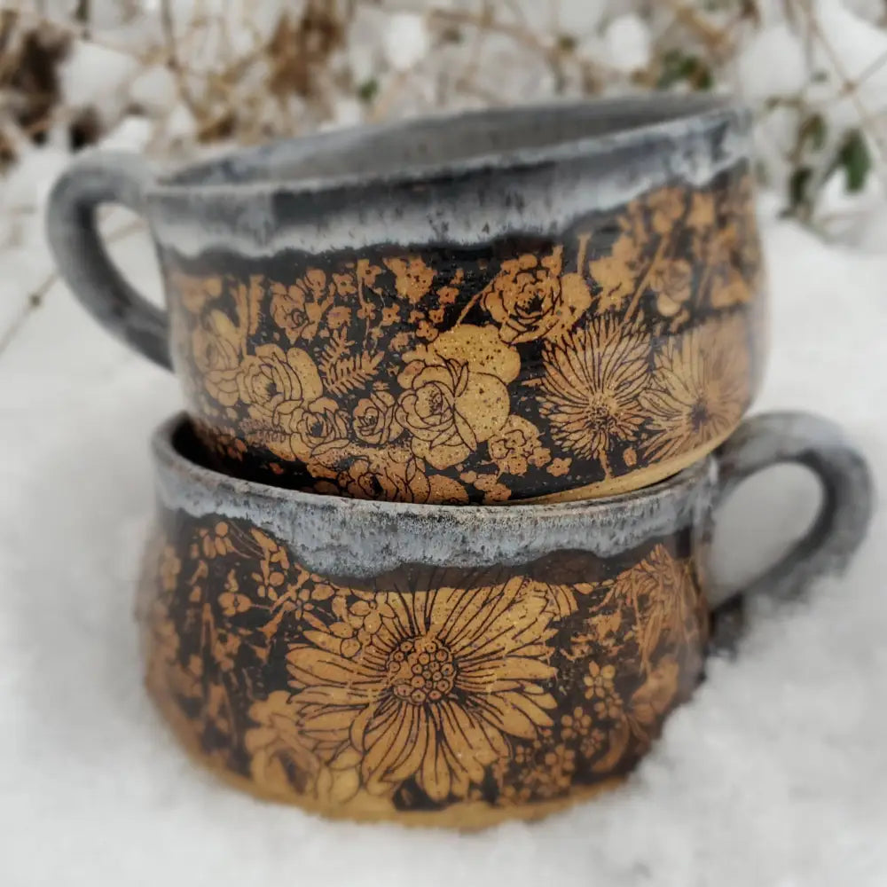 Two stacked ceramic soup bowls with black and gold floral design in handmade pottery