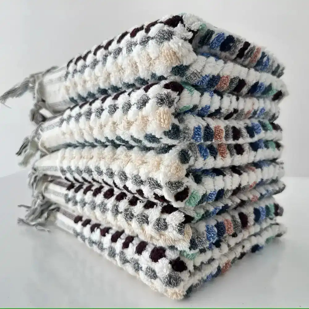 Handcrafted Turkish terrycloth cotton oversized hand towel with pastel colored dots.