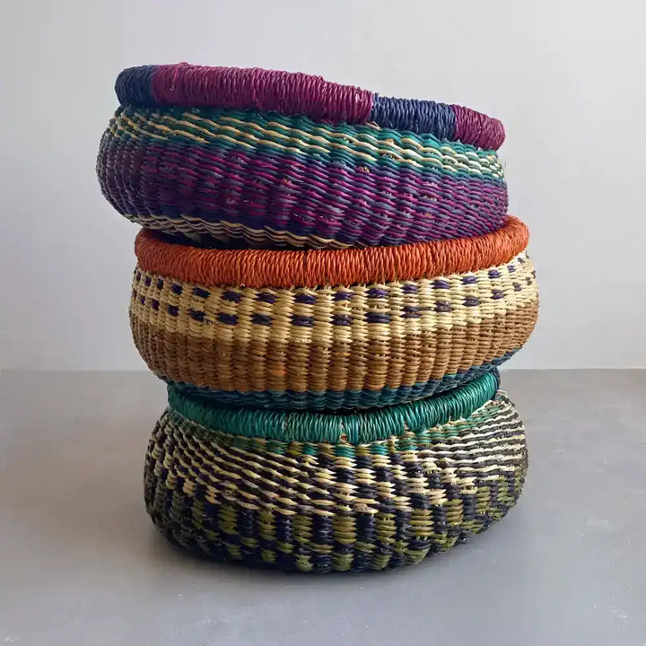 Three colorful medium baskets stacked on top of each other
