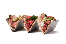 Stainless steel upright taco rack holding three steak tacos with radishes and herbs