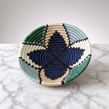 Handwoven star small sisal bowl with navy blue teal green cream and black geometric patterns and hanging loop