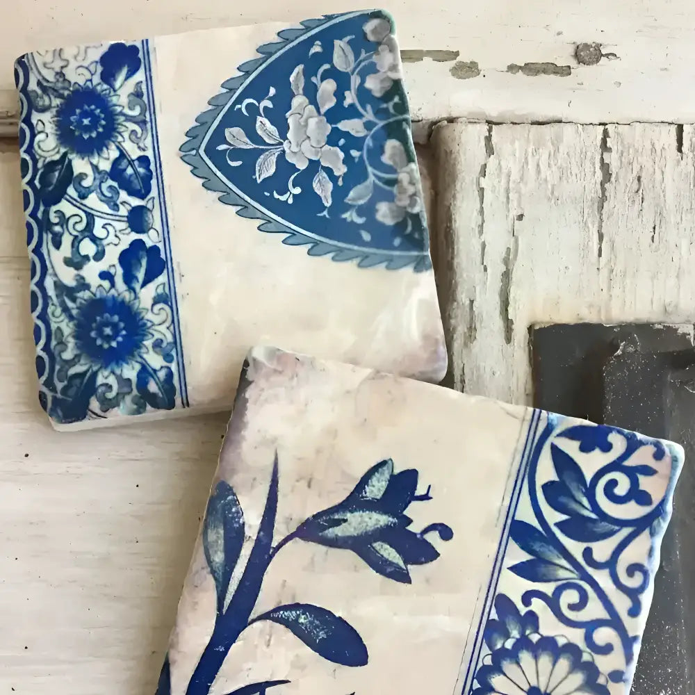 Blue and white ceramic tiles with floral patterns on a rustic wooden surface