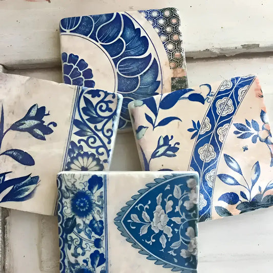 Decorative tiles with blue and white patterns on a wooden surface