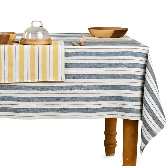 A wooden table with a navy striped tablecloth