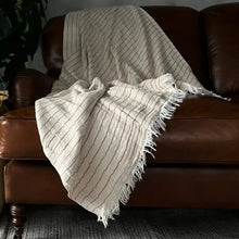 Cream-colored striped Turkish cotton blanket with fringed edges, perfect soft plush throw