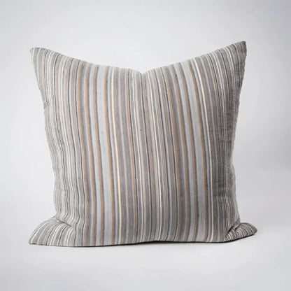Front side of striped pillow in blues, greens, and natural colors.