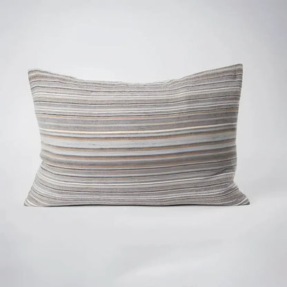 Front side of striped pillow in blues, greens, and natural colors.