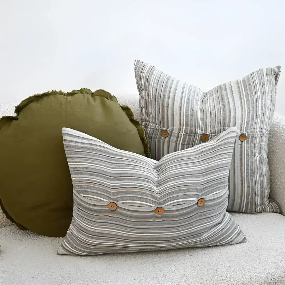 Back side of two striped pillow in blues, greens, and natural colors.