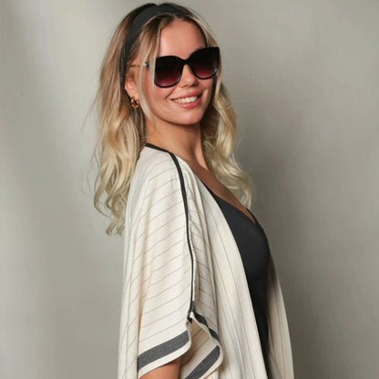 Woman with blonde hair in striped Turkish Kimono Cover Up and sunglasses