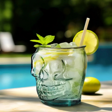 Clear glass sugar skull tumbler 15 oz made of recycled glass filled with ice lime slice and mint garnish
