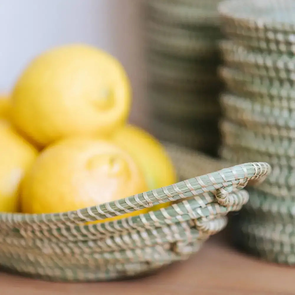 Sweetgrass African bread basket with bright yellow lemons and swamp grass weave