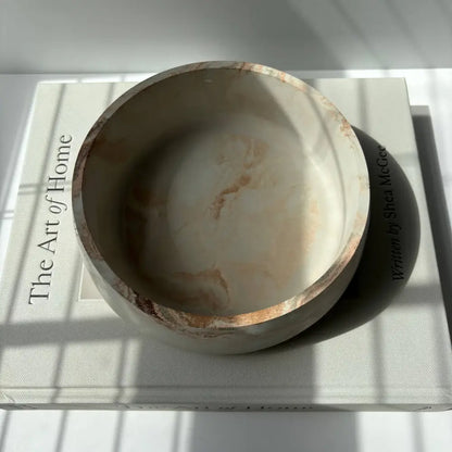 Handmade concrete bowl with marbled swirl design in black, gray, and gold. Smooth, minimalist and modern design.