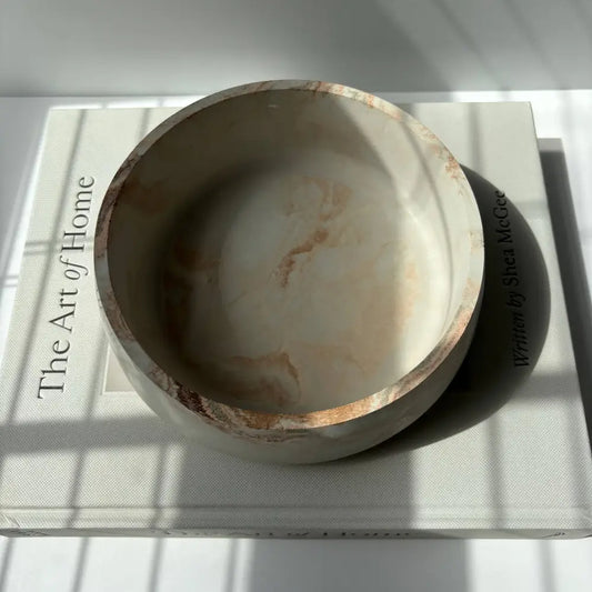 Handmade concrete bowl with marbled swirl design in black, gray, and gold. Smooth, minimalist and modern design.