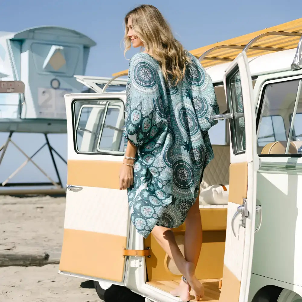 A flowing teal mandala kimono cover-up dress with three-quarter sleeves perfect for casual wear