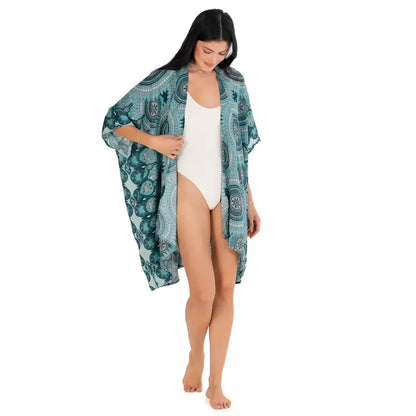 A flowing teal mandala kimono beach cover-up with white intricate mandala patterns perfect for summer wear