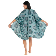 A flowing teal mandala kimono cover-up with white patterns and intricate circular mandala designs