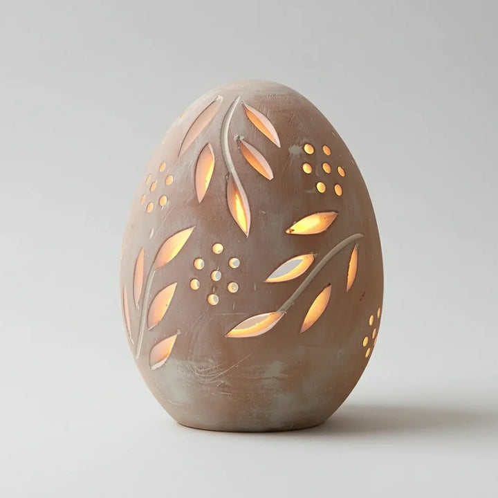 Brown Terra Cotta Egg Lantern with leaf and dot cut-outs glowing from inside