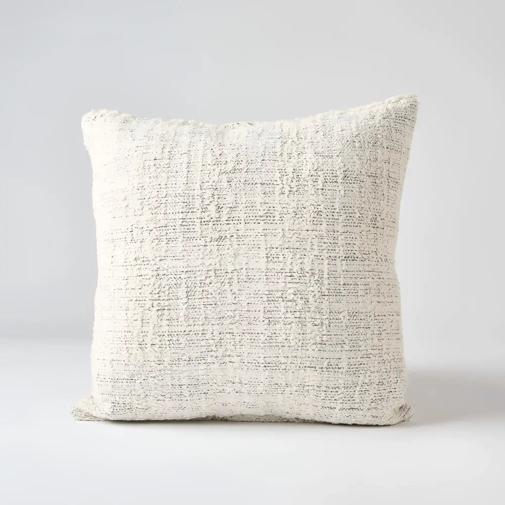 Off white and gray textured hand woven 20 inch x 20 inch pillow cover with three brown coconut buttons on one side 