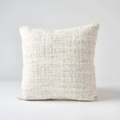 Off white and gray textured hand woven 20 inch x 20 inch pillow cover with three brown coconut buttons on one side 