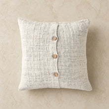 Off white textured cotton pillow cover with three wooden buttons down the center for cozy home decor