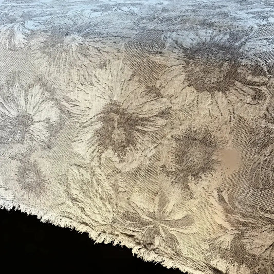 Textured linen bed runner with floral woven design in taupe and off white.