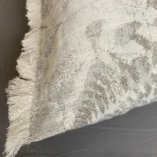 Pillow cover with woven fern designs in oatmeal color.