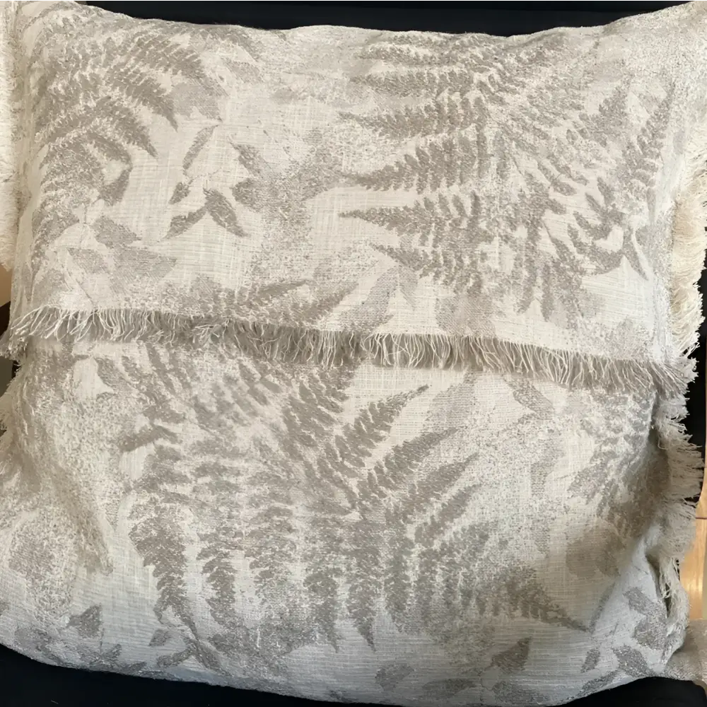 Pillow cover with woven fern designs in oatmeal color.