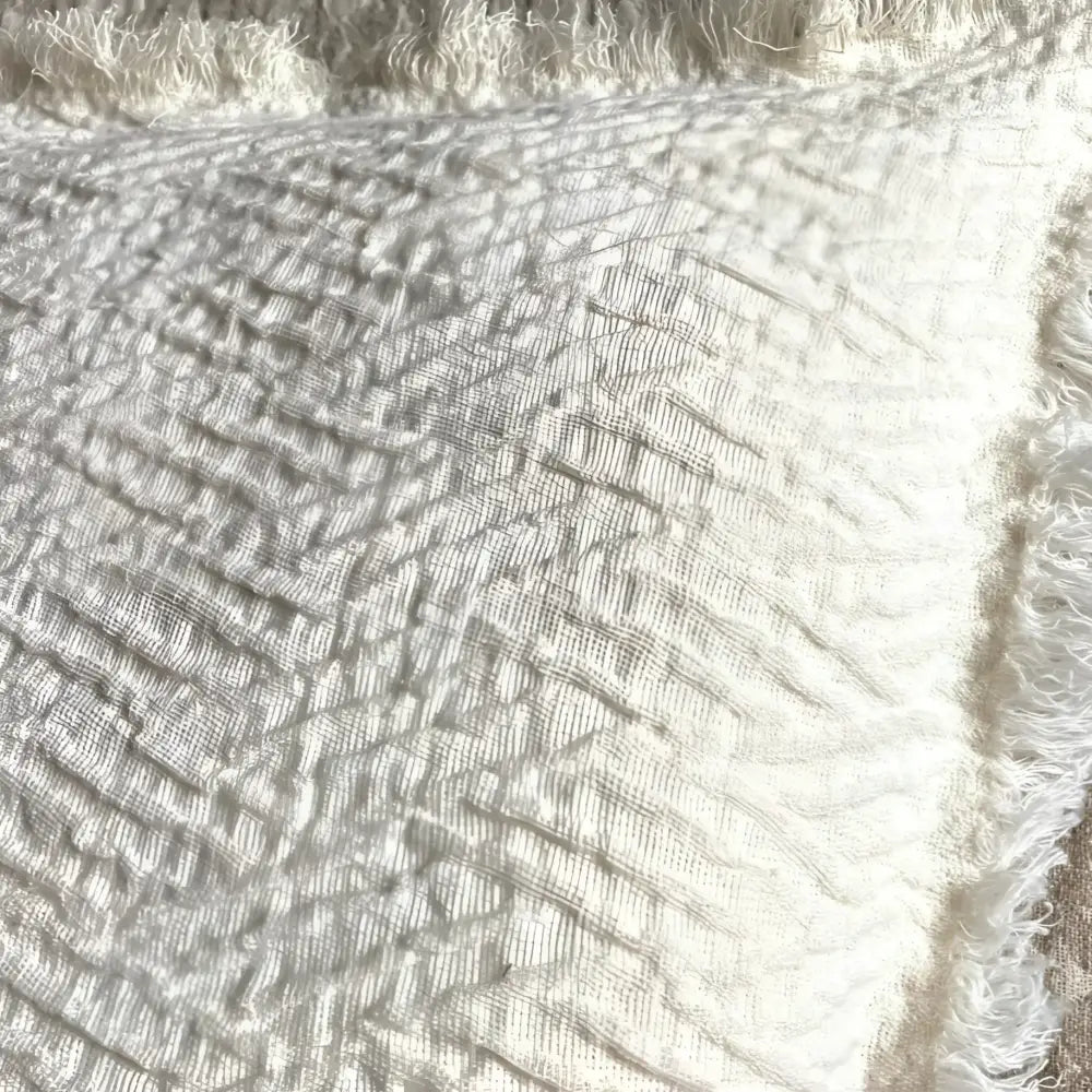 Linen pillow cover with a distinctive geometric textured weave in ivory.