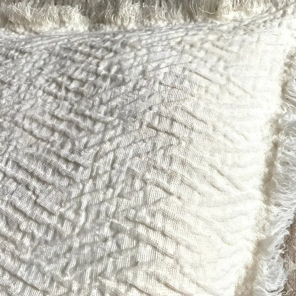 Linen pillow cover with a distinctive geometric textured weave in ivory.