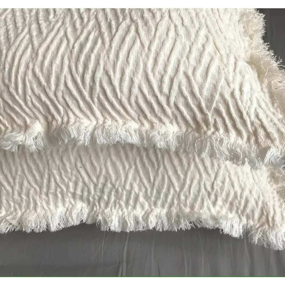 Linen pillow cover with a distinctive geometric textured weave in ivory.