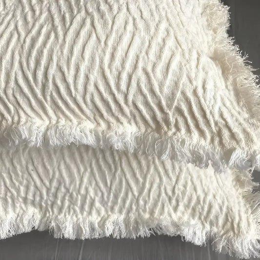 Linen pillow cover with a distinctive geometric textured weave in ivory.
